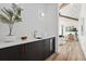 Modern wet bar with dark cabinetry and wine cooler at 7007 Point Of Rocks Rd, Sarasota, FL 34242