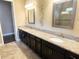 Elegant bathroom with double sinks, granite countertops, and large mirrors at 715 116Th Ne Ct, Bradenton, FL 34212