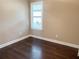 Spacious bedroom with dark hardwood floors and a window with shutters at 715 116Th Ne Ct, Bradenton, FL 34212