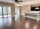 Open concept living area featuring hardwood floors and sliding glass doors at 715 116Th Ne Ct, Bradenton, FL 34212