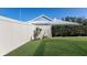 Landscaped backyard with a fence and lush green grass at 7203 41St E Ct, Sarasota, FL 34243