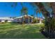 Single-story house with green walls, tile roof, and palm trees at 7203 41St E Ct, Sarasota, FL 34243