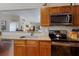 View of kitchen with granite countertops, stainless steel appliances, and wood cabinets at 7203 41St E Ct, Sarasota, FL 34243