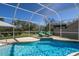 Inviting screened pool with lounge chairs, ready for relaxation at 7203 41St E Ct, Sarasota, FL 34243