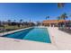 Inviting community pool with clear water, surrounded by a fence and lounge chairs at 7203 41St E Ct, Sarasota, FL 34243