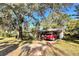 Home's exterior showcasing a carport and large trees at 729 41St St, Sarasota, FL 34234