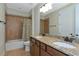 Double vanity bathroom with granite countertops and tiled shower at 7315 Bianco Duck Ct, Sarasota, FL 34240