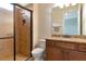 Bathroom with shower, toilet, granite vanity and dark wood cabinets at 7315 Bianco Duck Ct, Sarasota, FL 34240