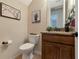 Small bathroom with toilet, sink, and granite countertop at 7315 Bianco Duck Ct, Sarasota, FL 34240