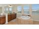 Elegant bathroom with a large soaking tub and double vanity at 7315 Bianco Duck Ct, Sarasota, FL 34240