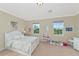 Cheerful bedroom with a full-size bed and lots of natural light at 7315 Bianco Duck Ct, Sarasota, FL 34240