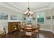 Formal dining room with hardwood floors, chandelier, and built-in hutch at 7315 Bianco Duck Ct, Sarasota, FL 34240