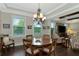 Bright dining room with hardwood floors, chandelier, and view to the Gathering room at 7315 Bianco Duck Ct, Sarasota, FL 34240