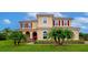 Two story house with red shutters, palm trees and manicured lawn at 7315 Bianco Duck Ct, Sarasota, FL 34240