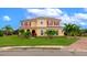 Two-story house with red shutters, palm trees and manicured lawn at 7315 Bianco Duck Ct, Sarasota, FL 34240