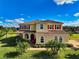 Two-story house with red shutters, tile roof, and landscaping at 7315 Bianco Duck Ct, Sarasota, FL 34240