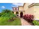 Landscaped front yard with brick pavers leading to house entrance at 7315 Bianco Duck Ct, Sarasota, FL 34240