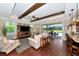 Bright living room with hardwood floors, fireplace, and access to the pool area at 7315 Bianco Duck Ct, Sarasota, FL 34240