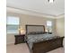 Spacious main bedroom with a large bed and tray ceiling at 7315 Bianco Duck Ct, Sarasota, FL 34240