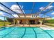 Inviting pool area with screened enclosure, spacious deck, and adjacent patio at 7315 Bianco Duck Ct, Sarasota, FL 34240