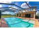 Large screened pool with patio, spa, and backyard access to golf course at 7315 Bianco Duck Ct, Sarasota, FL 34240