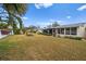 Spacious backyard with grassy area and partial view of neighboring homes at 7460 W Country Club N Dr, Sarasota, FL 34243