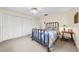 Bright bedroom with a metal bed frame and built-in closet at 7460 W Country Club N Dr, Sarasota, FL 34243