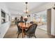 Elegant dining room with an oval table and wicker chairs at 7460 W Country Club N Dr, Sarasota, FL 34243