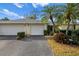 Two-car garage, attractive landscaping, and a welcoming entrance at 7460 W Country Club N Dr, Sarasota, FL 34243