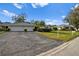 Front view of two-unit home with double garage and landscaping at 7460 W Country Club N Dr, Sarasota, FL 34243