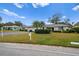 Single-story home with attached garage and well-manicured lawn at 7460 W Country Club N Dr, Sarasota, FL 34243