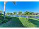 Landscaped backyard with lush lawn and peaceful lake views at 7555 Tori Way, Lakewood Ranch, FL 34202