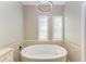 Round bathtub with modern fixtures in a stylish bathroom at 7555 Tori Way, Lakewood Ranch, FL 34202