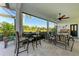 Relaxing covered patio with seating area and tranquil water views at 7555 Tori Way, Lakewood Ranch, FL 34202