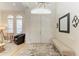 Bright and airy entryway with double doors and a stylish bench at 7555 Tori Way, Lakewood Ranch, FL 34202