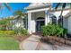 Inviting front entry with lush landscaping and a welcoming walkway at 7555 Tori Way, Lakewood Ranch, FL 34202