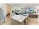 Open kitchen island with white quartz countertops and gray cabinets at 7555 Tori Way, Lakewood Ranch, FL 34202