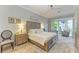 Main bedroom with a king-size bed and bay window at 7555 Tori Way, Lakewood Ranch, FL 34202