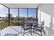 Relaxing screened balcony with patio furniture at 757 Beach Rd # 208, Sarasota, FL 34242