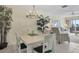 Bright dining room with chandelier and living room view at 757 Beach Rd # 208, Sarasota, FL 34242