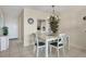 Simple dining area with white table and four chairs at 757 Beach Rd # 208, Sarasota, FL 34242