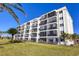 Three-story condo building with green lawn at 757 Beach Rd # 208, Sarasota, FL 34242