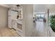 Kitchen with white appliances and view into living area at 757 Beach Rd # 208, Sarasota, FL 34242