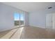 Bright bedroom with tile floors and sliding glass doors to balcony at 800 N Tamiami Trl # 1502, Sarasota, FL 34236