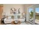 Light-filled living room features a comfy sofa, and sliding glass doors leading to a balcony at 8005 20Th W Pl, Bradenton, FL 34209