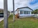 Side view of a white manufactured home with landscaping at 808 53Rd E Ave # 76, Bradenton, FL 34203