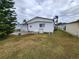 Mobile home with a side view showcasing its exterior condition and landscaping at 808 53Rd E Ave # 76, Bradenton, FL 34203