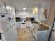 Efficient kitchen with white cabinets and a tiled floor at 808 53Rd E Ave # 76, Bradenton, FL 34203