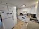 White kitchen features, appliances, and tile floor at 808 53Rd E Ave # 76, Bradenton, FL 34203