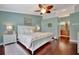 Spacious primary bedroom with wood floors and en-suite bathroom at 839 Manchester Woods Dr # 25, Sun City Center, FL 33573